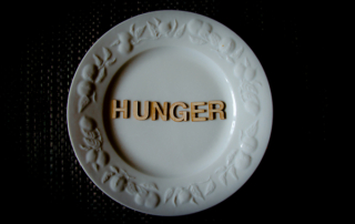 Hunger words on white plate