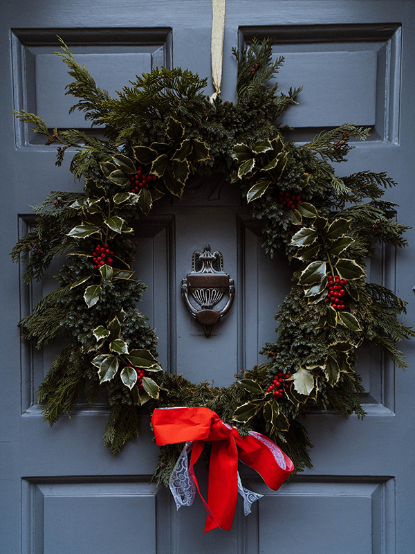 Christmas holly wreath on door. 